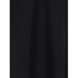 فستان أسود واسع بدون أكمام بياقة هالتر مزين بفيونكة