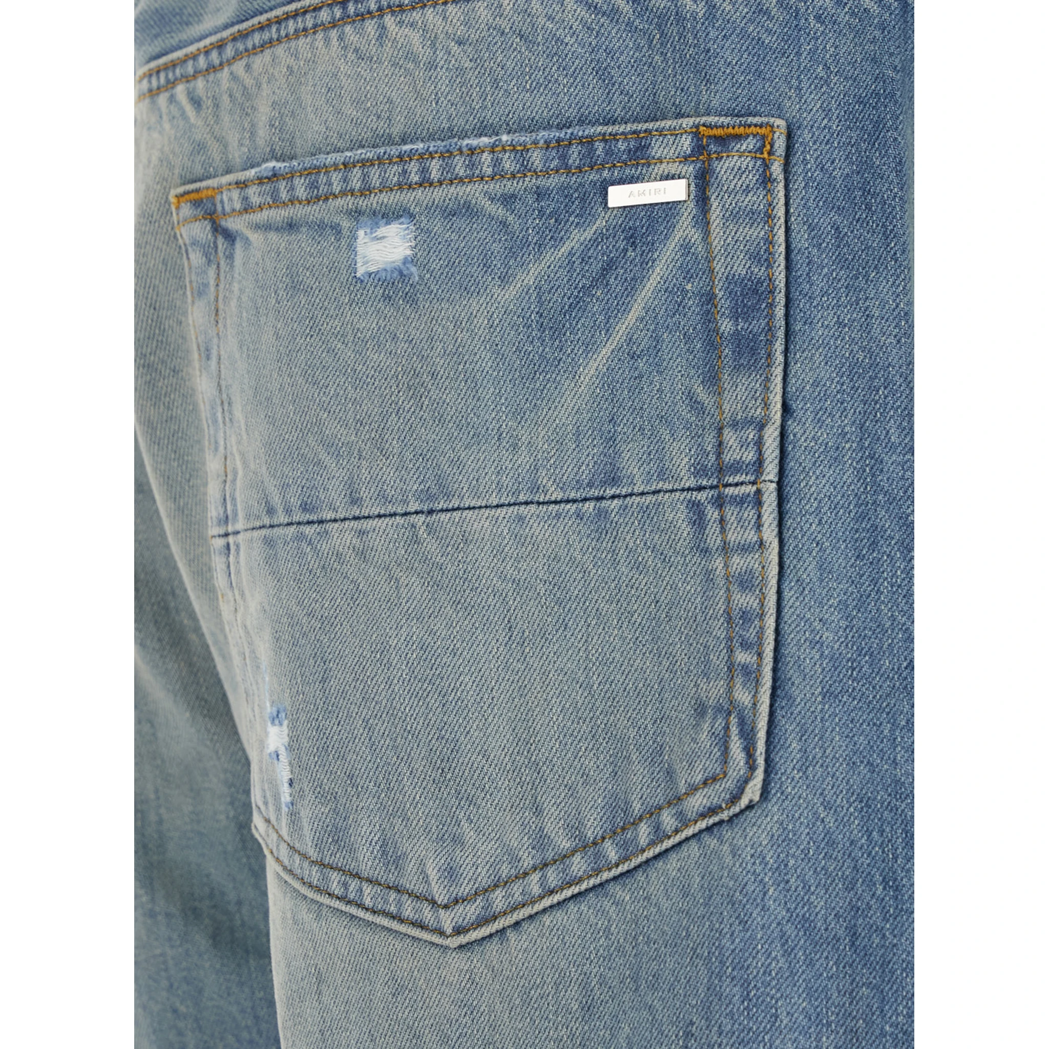 Blue Jeans with Ripped Details on the Front and Logo Patch on the Rear in Denim Man