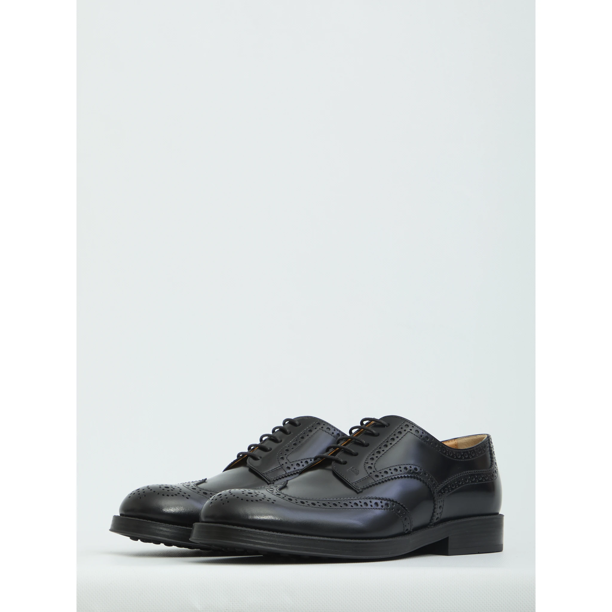 Laced up shoes with perforations