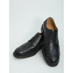 Laced up shoes with perforations