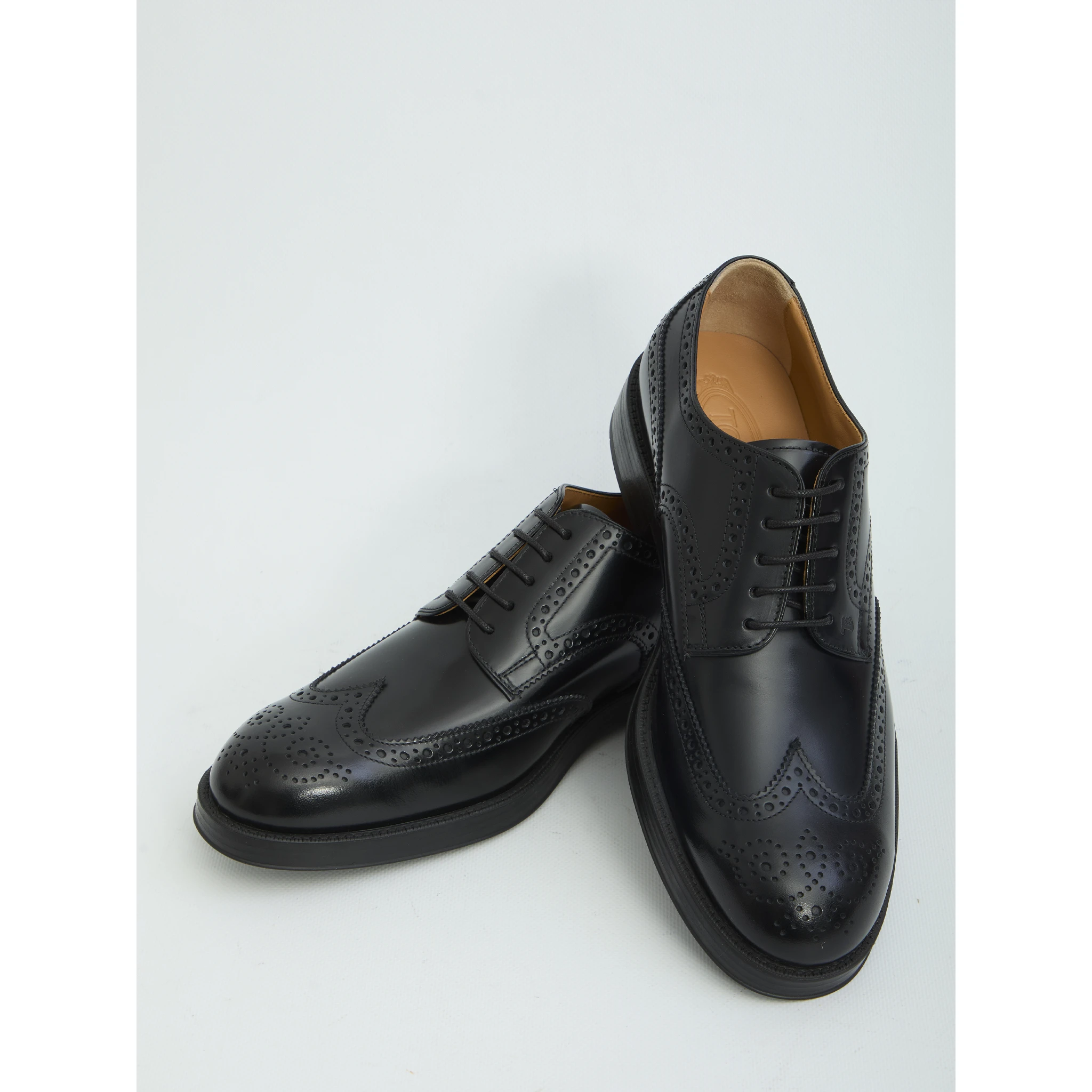 Laced up shoes with perforations