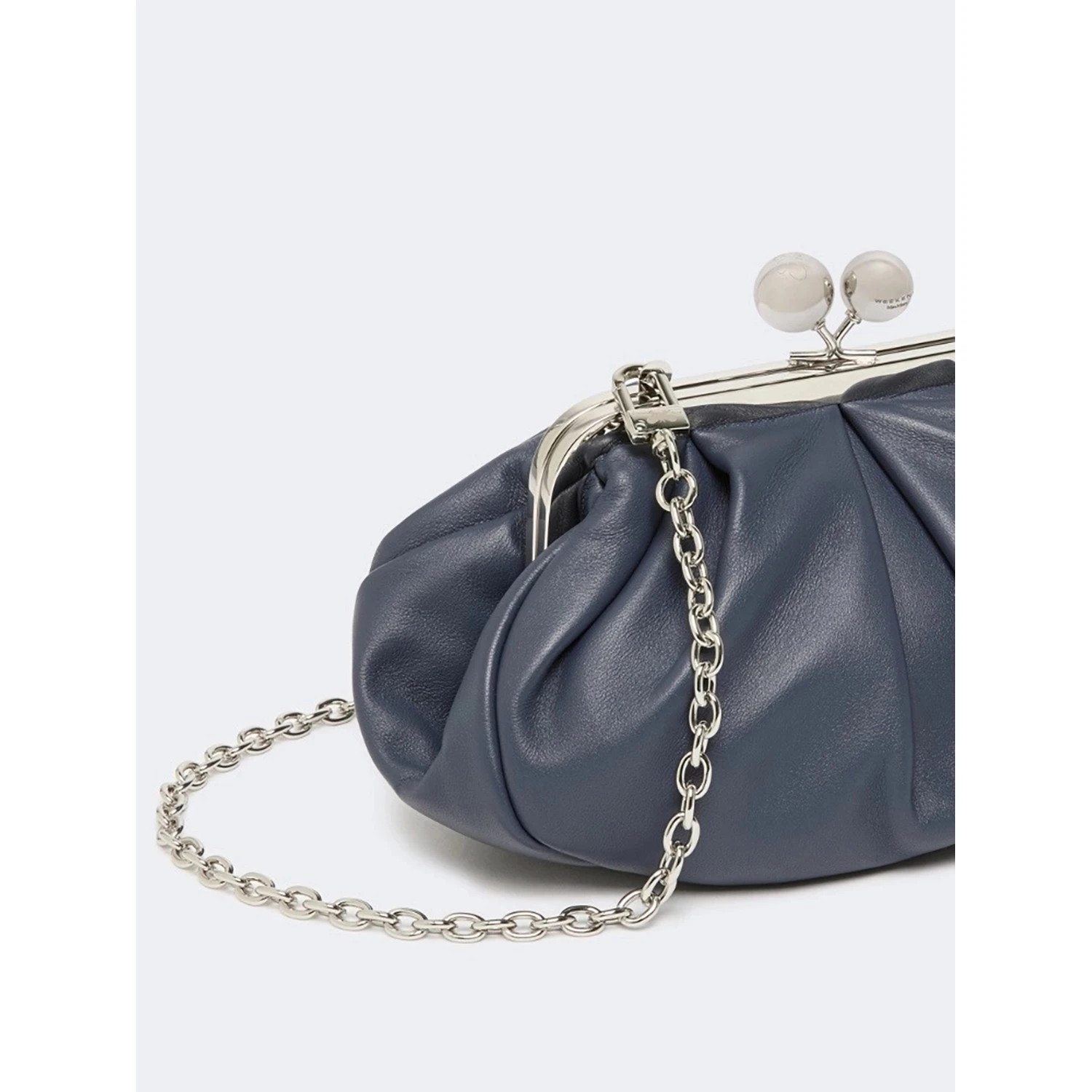 WEEKEND MAX MARA is accompanied by a handbag