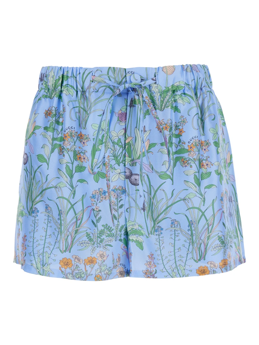 Light blue Shorts with elasticated waist and drawstring and all-over floral print in silk for women