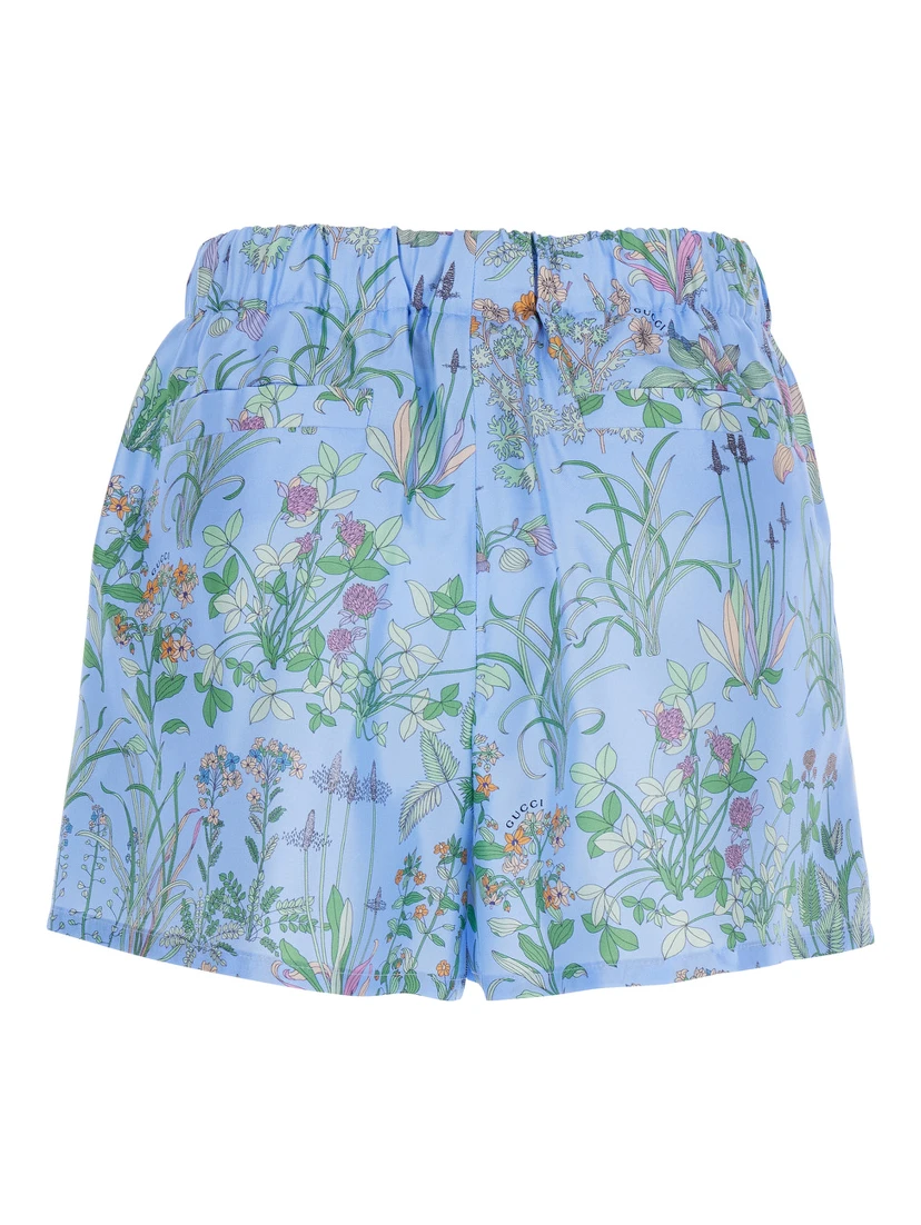 Light blue Shorts with elasticated waist and drawstring and all-over floral print in silk for women