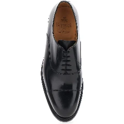 Black lace-up shoes with rounded toe and low heel in leather for men