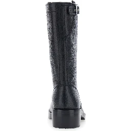 Black boots with decorative buckle and low heel in leather for women