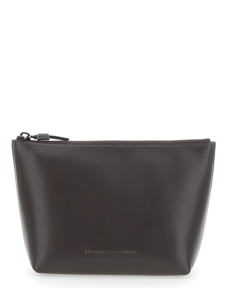 Brown beauty case with embossed logo lettering on the front in leather women
