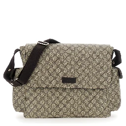 Beige Crossbody changing  bag with adjustable strap and flap closure on the front in GG canvas baby