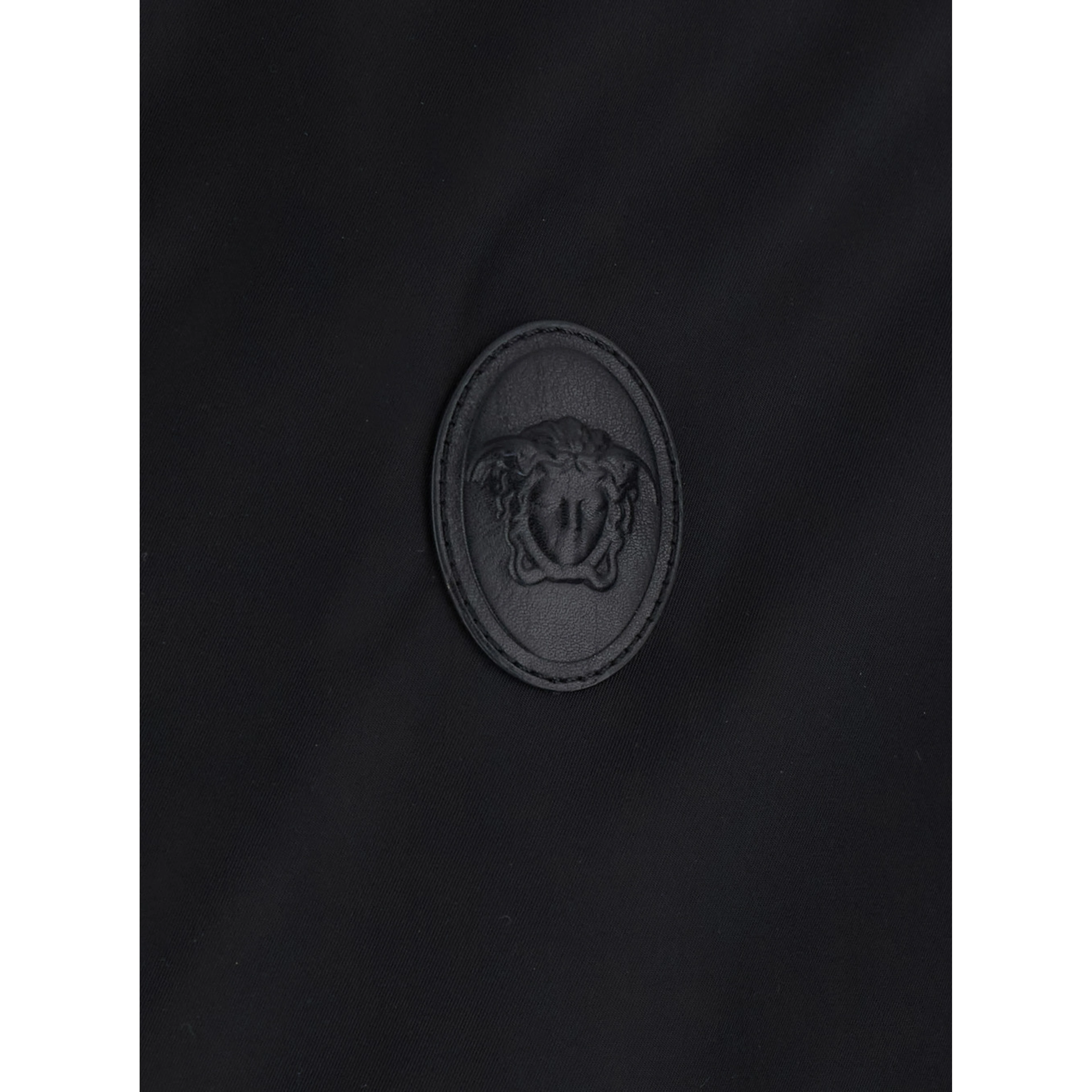 Black jacket with Medusa logo patch on the front in Tech Fabric men