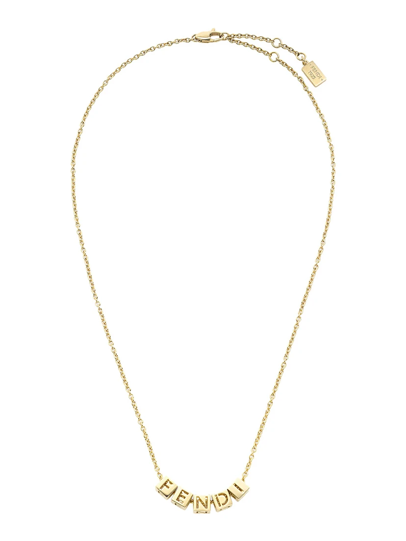 Gold-colored Necklace with lobster clasp at the back and cubes with Logo lettering in metal for women