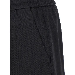 Joggers with pockets and ribbed hems in black Virgin wool for men