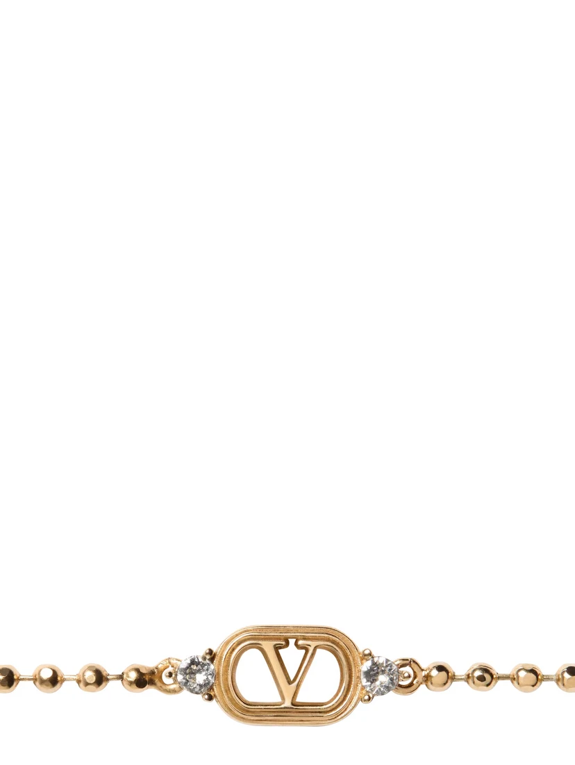 metallic colored Bracelet with Vlogo plate and applied rhinestones in brass for women