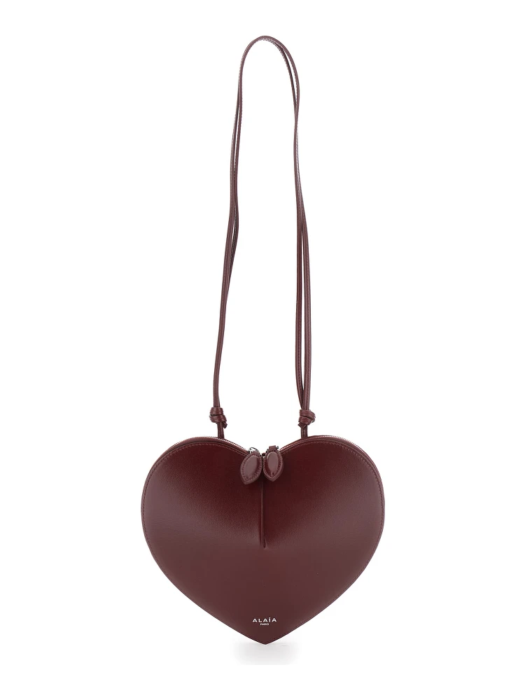 COEUR Bag in burgundy calf leather with closure and shoulder strap, unisex