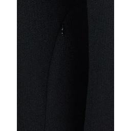 Coat with lapel collar, featuring long sleeves and front button closure. Made of wool, black, womens.